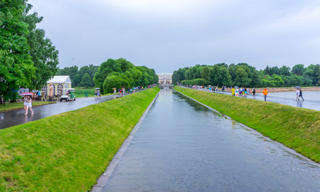 RUSSIA, Peterhof - JULY, 17, 2013. The Grand Canal with fountain mascarons in the lower park and the Grand Palaceのeditorial素材
