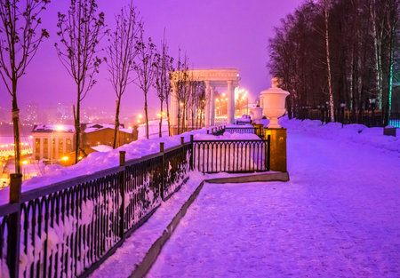 Rotunda, parapet and trees on the embankment of the Izhevsk pond in Russia, in the evening, in the winter before sunsetの写真素材