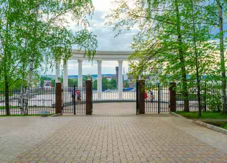 Beautiful rotunda on the shore of the pond in Izhevsk, in Russia, in the evening. View from the parkの写真素材
