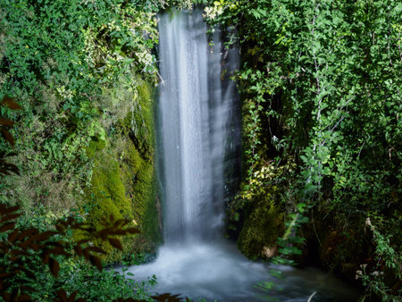 A waterfall, taken at night with a slow shutter in the town of Moustiers-Sainte-Marie, France.の写真素材
