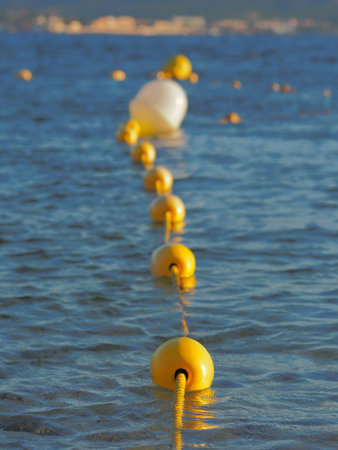 A close up of several buoys in the water.の写真素材