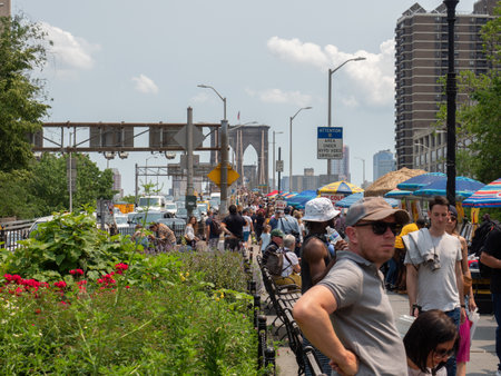 New York, USA - May 31, 2019: A large crowd of tourists head towards the Brooklyn bridge.のeditorial素材