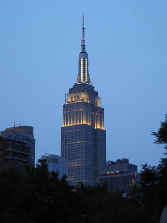New York, USA - June 2, 2019: Image of the Empire State Building towering over its surroundings at...