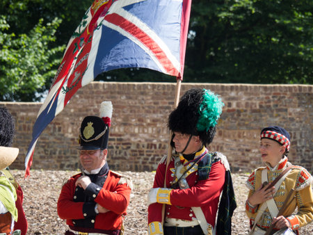 Waterloo, Belgium - June 18 2017: A British banner carrier presents the union jack during the re-enactment of the battle of Waterloo.のeditorial素材