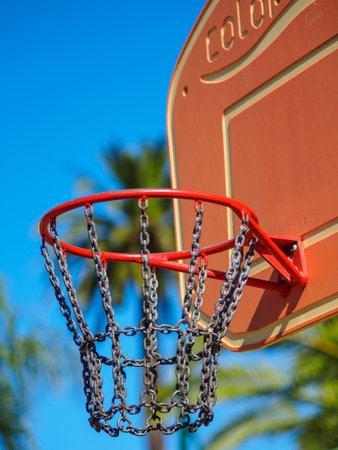 Cannes, France - August 11 2017: A close up of a basketball hoop with some palm trees on a blurred background.のeditorial素材