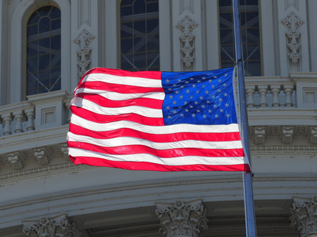 American flag half-mast on top of the capitol.