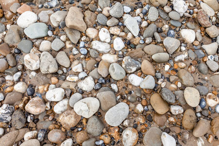 at the beach there is a lot of bouldersの写真素材