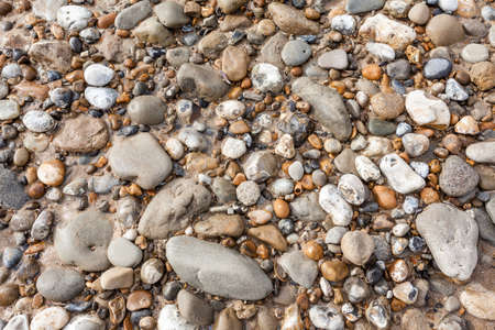 at the beach there is a lot of bouldersの写真素材