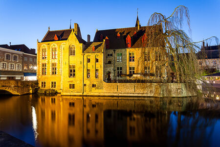 In Brugges at sunset during the blue hour, you see the refection of the building and the towerの写真素材