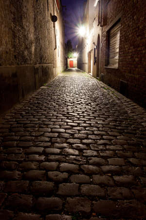 a narrow street with cassia with street lightsの写真素材