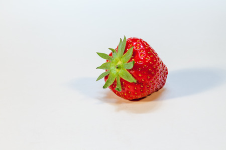 this strawberries lightly shelf on the tableの写真素材