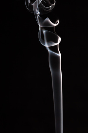 white and blue smoke whit black backgroundの写真素材