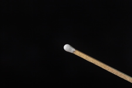one match whit white phosphorus on black の写真素材