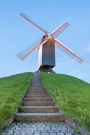 on a hill in Bruges there are a windmillの写真素材