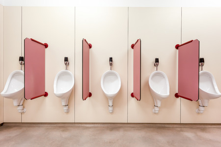 urinals in an old building for men only
