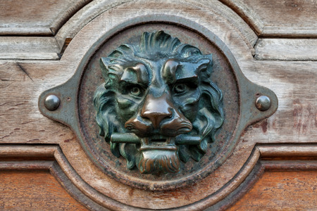 on an old door is there an lion head doorknobの写真素材
