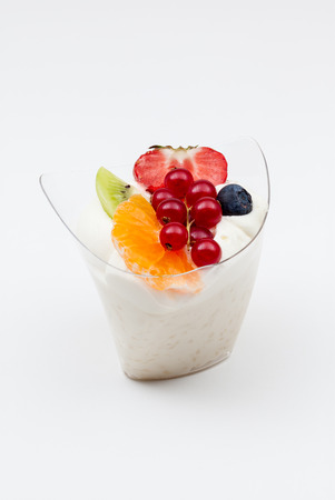an delicious rice pudding of strawberry,  orange, kiwi and whipped creamの写真素材