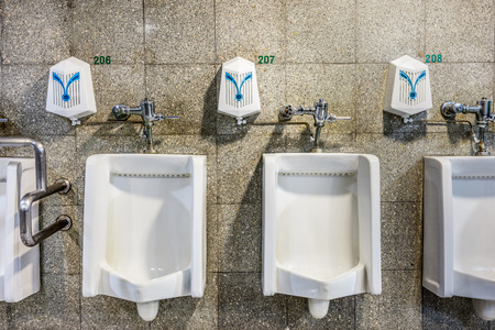 urinals in an old building for men onlyの写真素材