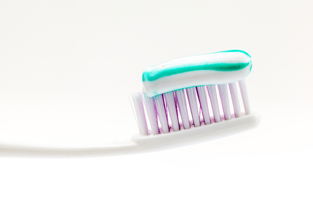 an toothbrush with toothpaste with green and white colors