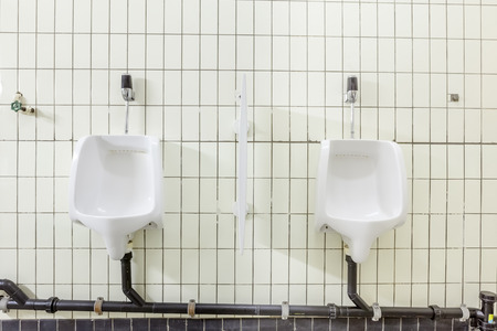 urinals in an old building for men onlyの写真素材