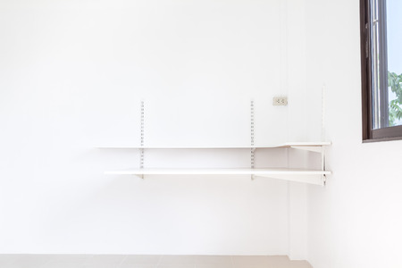 shelf bracket and which is fixed to the white wallの写真素材