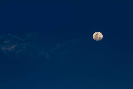 in the morning on a beautiful day is beginning this moon in the blue skyの写真素材