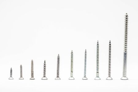 various screws in metal as white backgroundの写真素材
