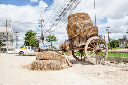 on a parking lot, this old coach with strawの写真素材