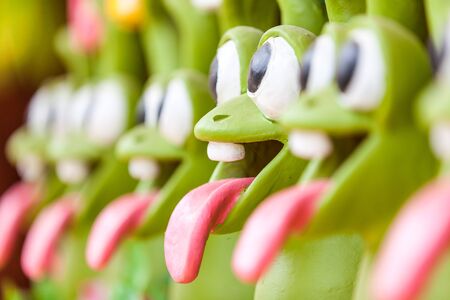 a few stone frogs with their tongues outの写真素材