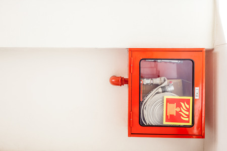 an fire hose hanging on the wall in an staircaseの写真素材