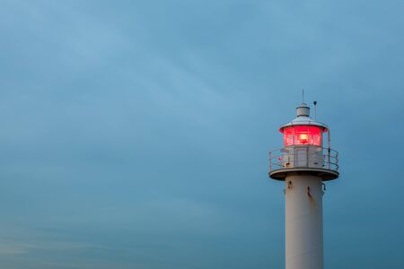 lighthouse with red lightの写真素材