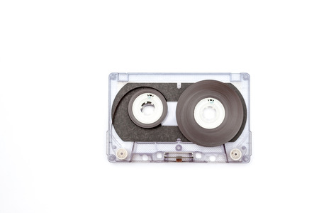 unrolled music cassette on an white backgroundの写真素材
