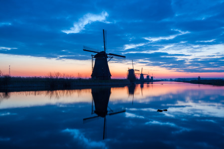 on the water there are several windmills in Kinderdijk in Hollandの写真素材