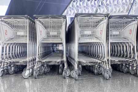 several luggage cart at the airport in the departure hallの写真素材