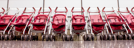 several strollers in the departure hall of the airport
