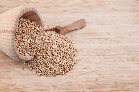 these herbs are oats in an wooden bowl with spoon