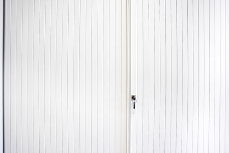 an key in the key lock to an sliding doorの写真素材