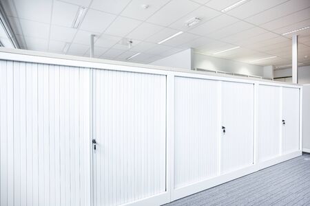 on a full row of cabinets in an empty officeの写真素材