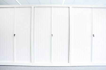 on a full row of cabinets in an empty officeの写真素材