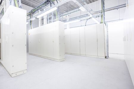 in the basement of an industrial building there is an room with electrical cabinets