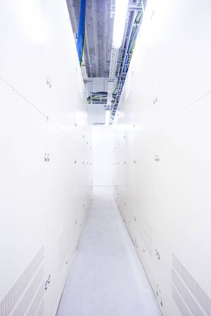 in the basement of an industrial building there is an room with electrical cabinets