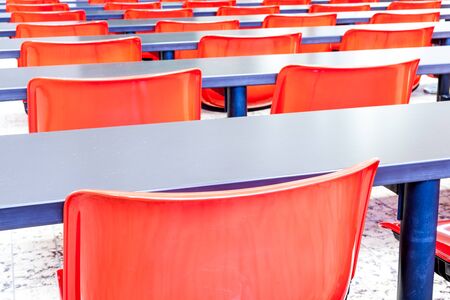 This auditorium is in the university whit red chairs