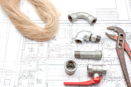 Plumbing Tools Arranged On House Plans whit wrench and water valves