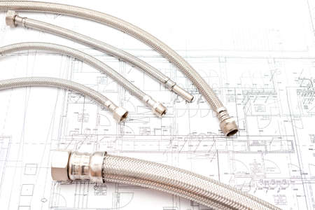 on an house plan lie several hoses