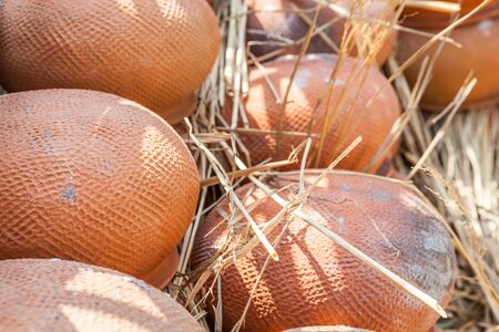 stacked red stone pots in an pottery