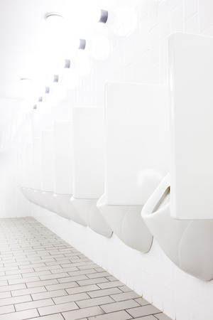 urinals in an old building for men onlyの写真素材