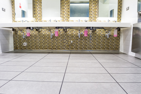 in an public restroom hangs on an wall of an white sinkのeditorial素材
