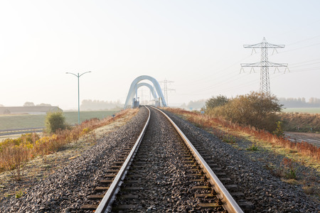 railway disappearing into the distance along the fieldの写真素材