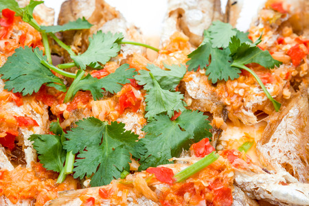 prepared fish with red peppers and some coriander leaves