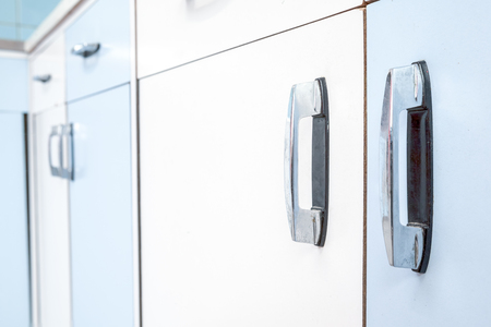 handle of an old kitchen cabinet in close upの写真素材